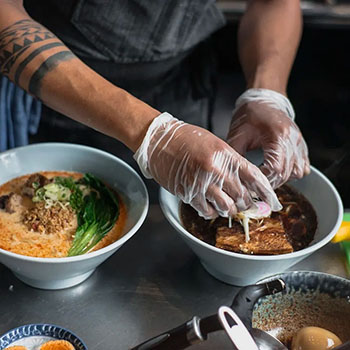 Chef carefully preparing ingredients in a serving dishes