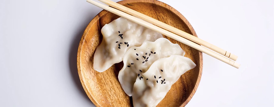 Potstickers on a plate with chopsticks